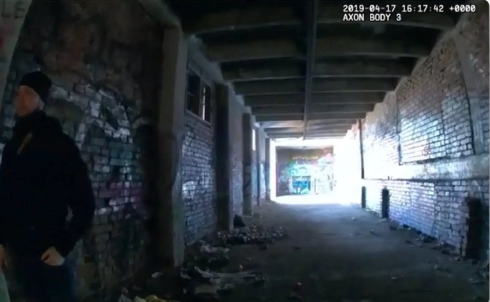 Footage of a dark covered passage from a first-person camera’s perspective.